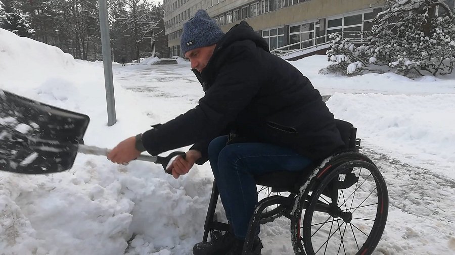 Людям на колясках пришлось самим расчищать парковку возле самоуправления (видео) - В Висагинасе